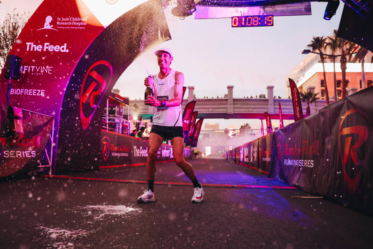 Andy Wacker sprays champagne after coming in first for the men’s half marathon during th ...