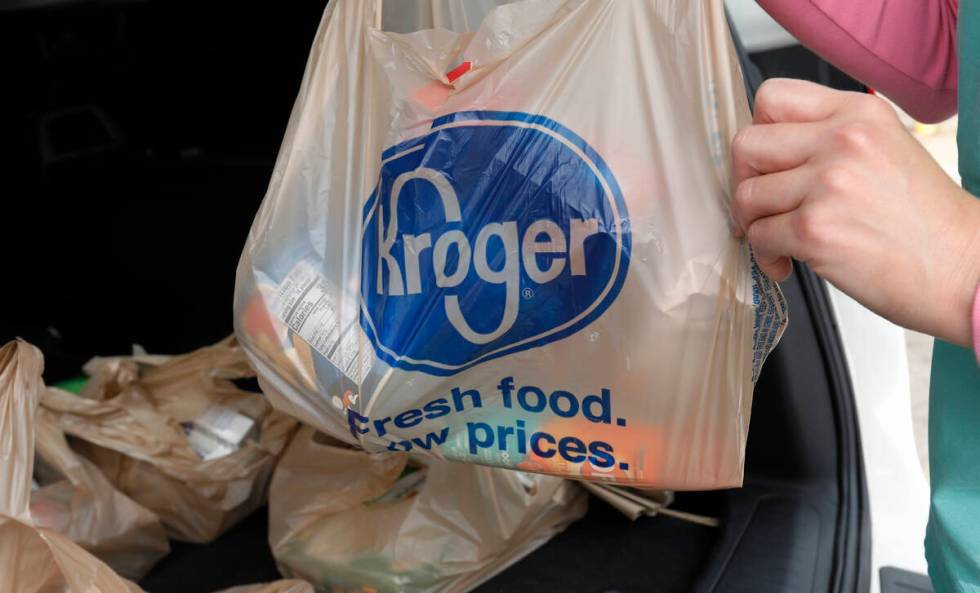 FILE - A customer removes her purchases at a Kroger grocery store in Flowood, Miss., Wednesday, ...