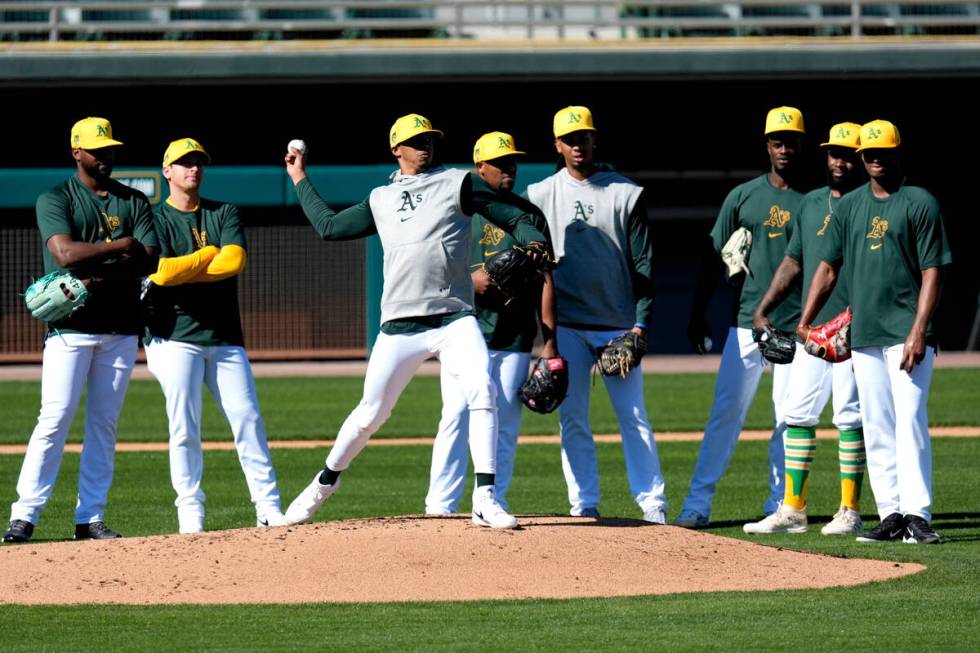 Oakland Athletics players run drills during a baseball spring training workout, Friday, Feb. 16 ...