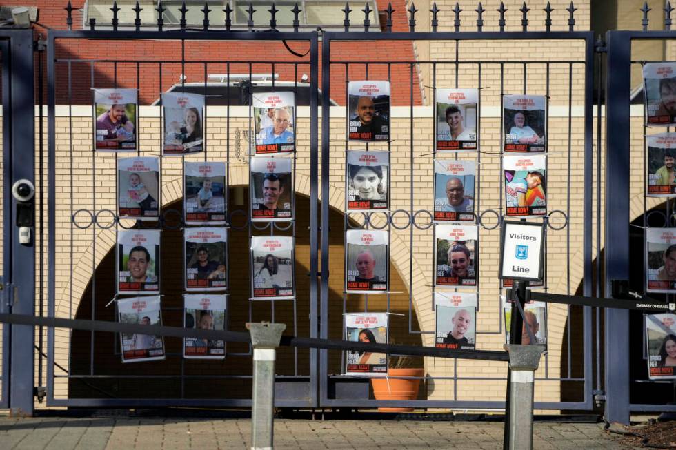 Posters of kidnapped people line the gates at the entrance of the Israeli Embassy, Monday, Feb. ...