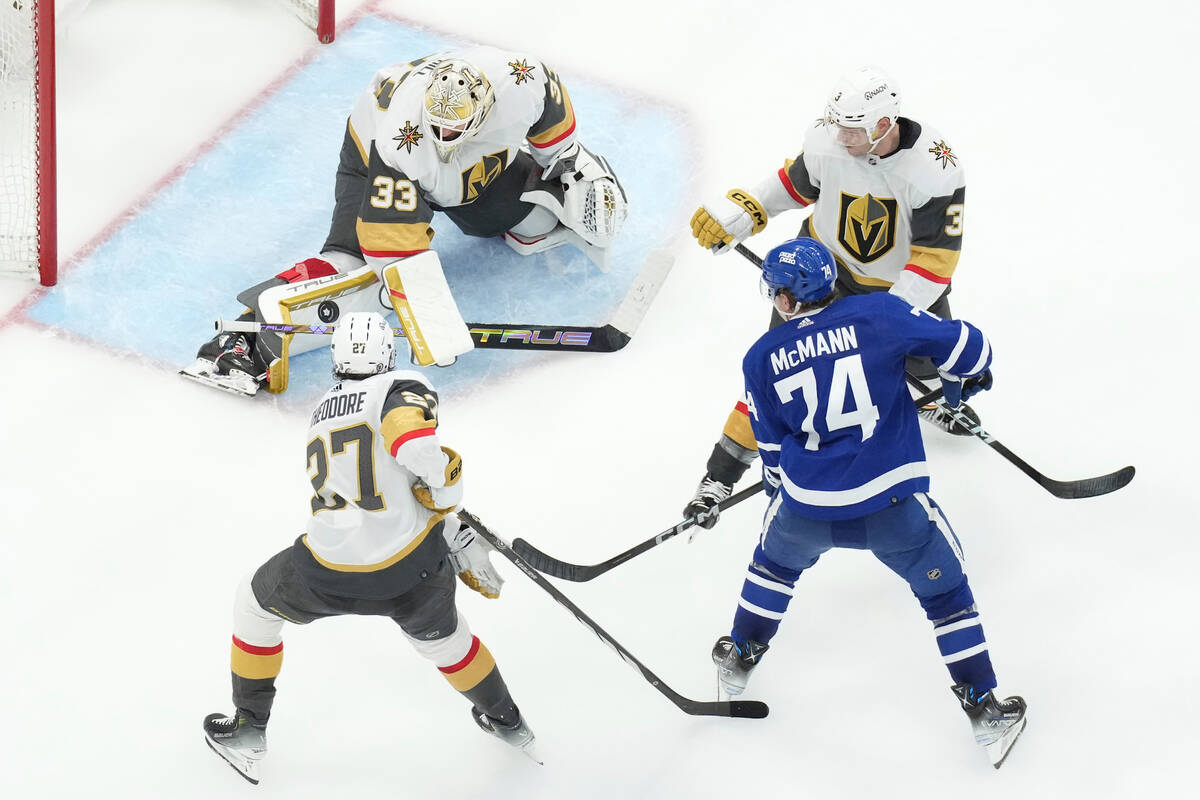 Vegas Golden Knights goaltender Adin Hill (33) makes a save on Toronto Maple Leafs' Bobby McMan ...