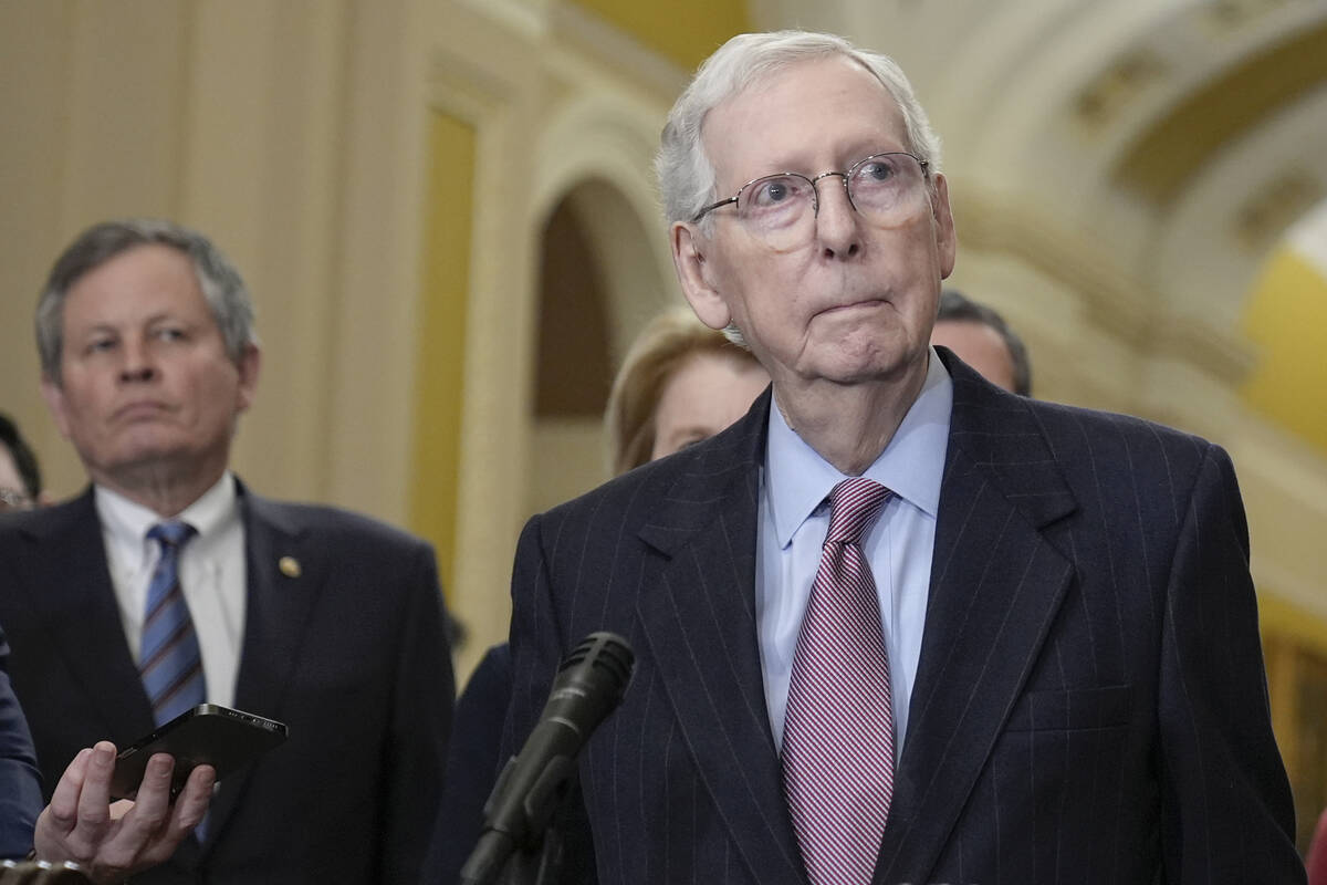 Senate Minority Leader Mitch McConnell, R-Ky., right, talks after a policy luncheon on Capitol ...