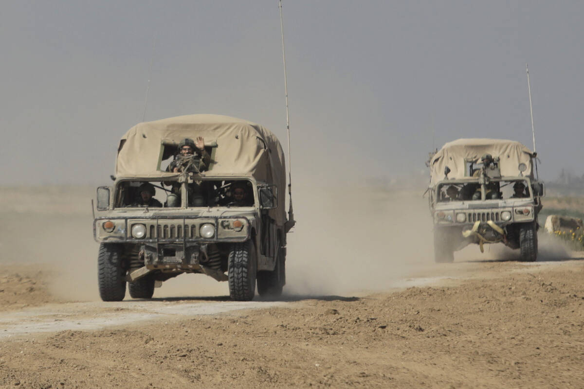 Israeli IDF vehicles move a long the border with the Gaza Strip on Feb. 28, 2024, in Southern i ...