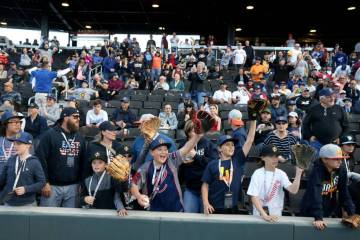 Fans hope for a ball from the players during opening night for the Las Vegas Aviators at Las Ve ...