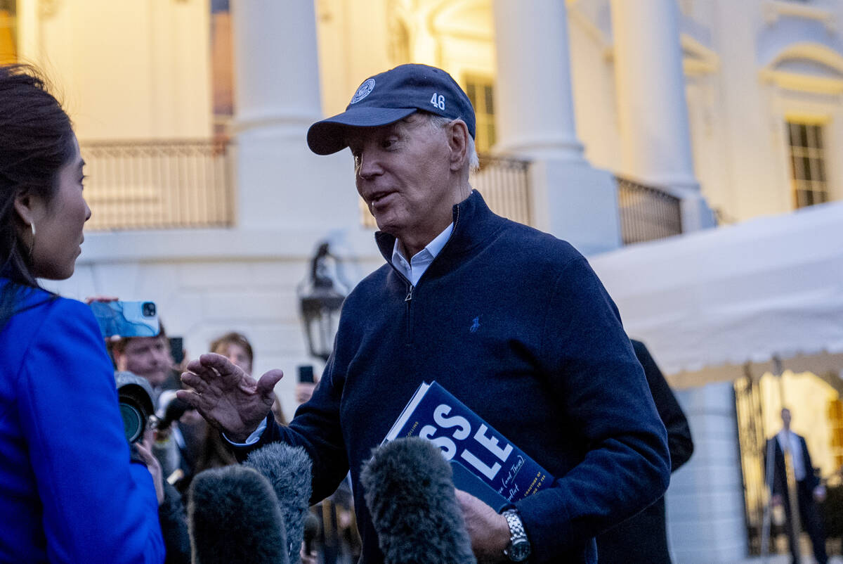 President Joe Biden speaks to members of the media before boarding Marine One on the South Lawn ...