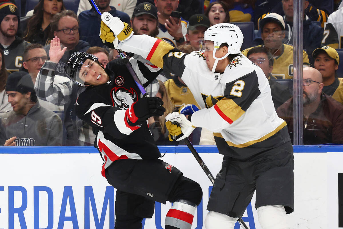 Buffalo Sabres center Peyton Krebs (19) is checked by Vegas Golden Knights defenseman Zach Whit ...