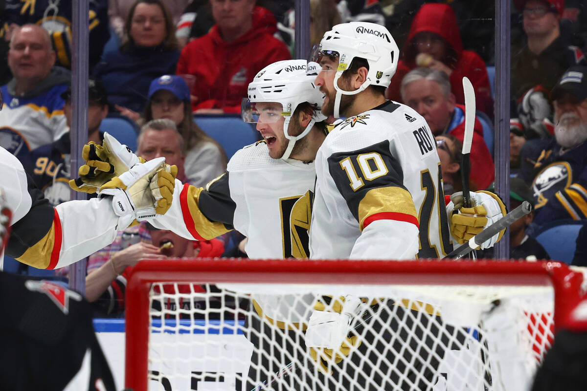 Vegas Golden Knights center Brendan Brisson (19) celebrates his goal with center Nicolas Roy (1 ...