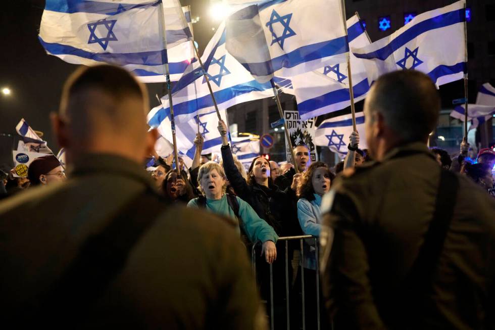 People protest against Israeli Prime Minister Benjamin Netanyahu's government in Tel Aviv, Isra ...