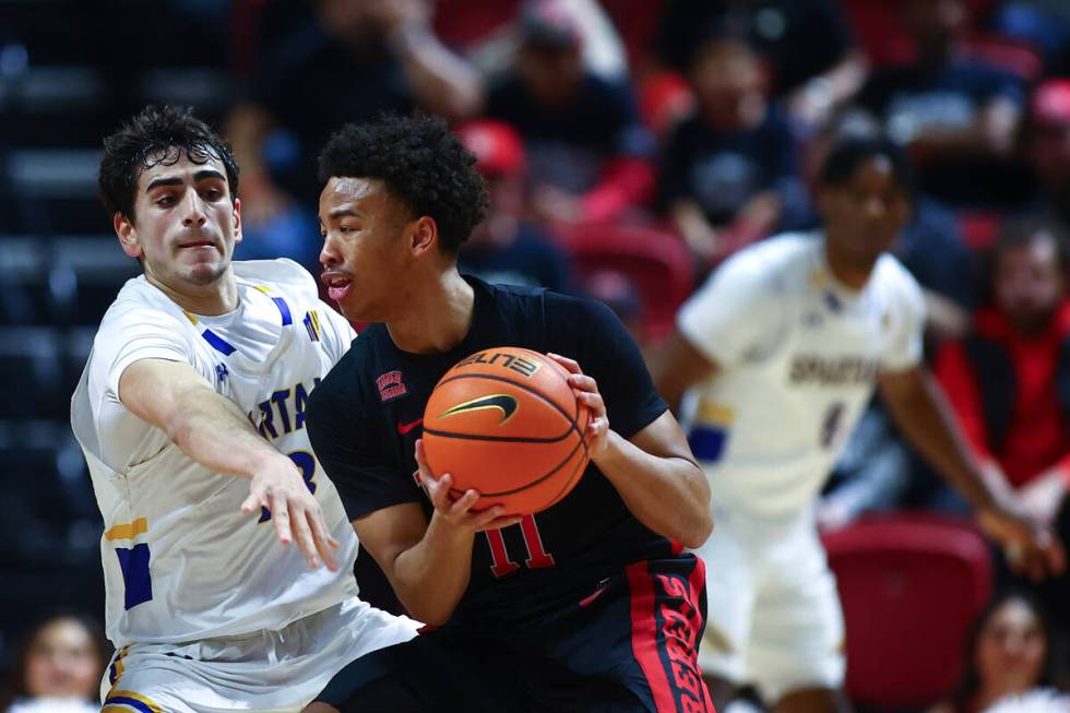 UNLV Rebels guard Dedan Thomas Jr. (11) dribbles against San Jose State Spartans guard Alvaro C ...