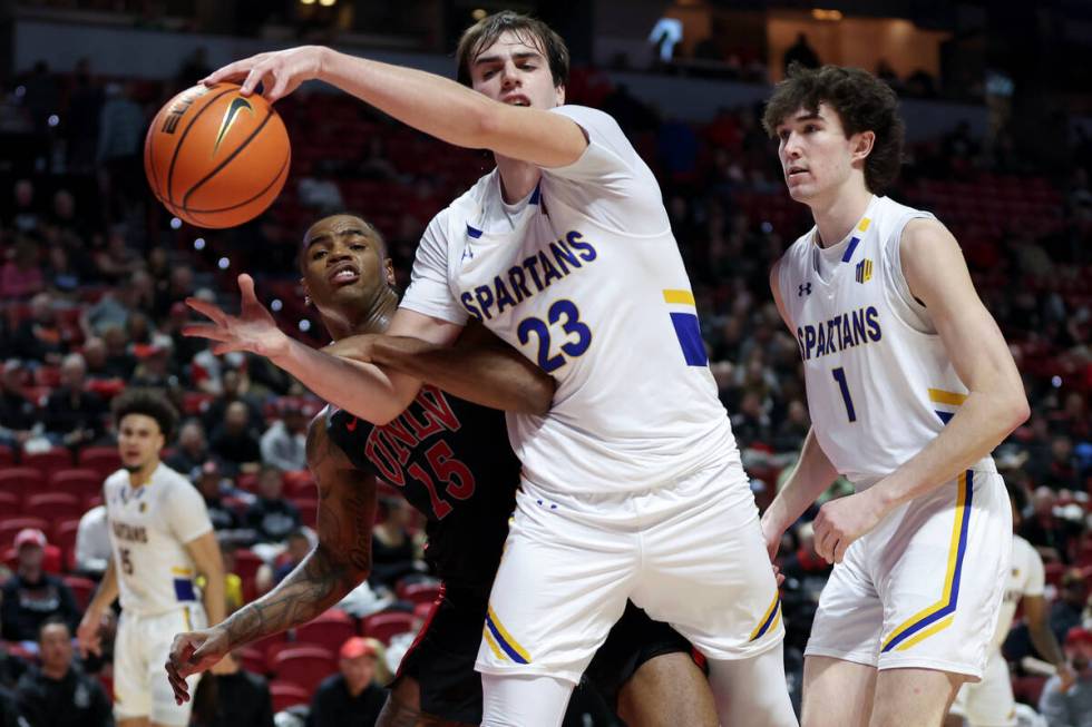 UNLV Rebels guard Luis Rodriguez (15) and San Jose State Spartans forward Diogo Seixas (23) tan ...