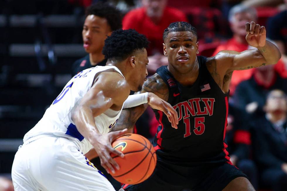 UNLV Rebels guard Luis Rodriguez (15) defends against San Jose State Spartans guard Myron Amey ...