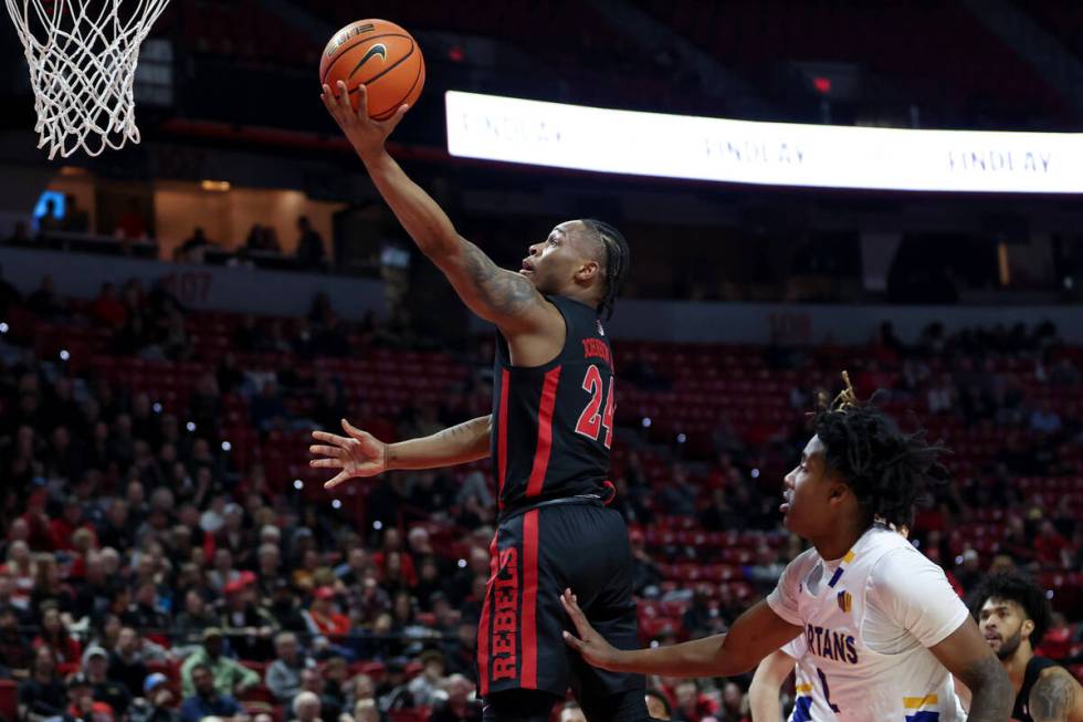 UNLV Rebels guard Jackie Johnson III (24) scores over San Jose State Spartans guard Rickey Mitc ...