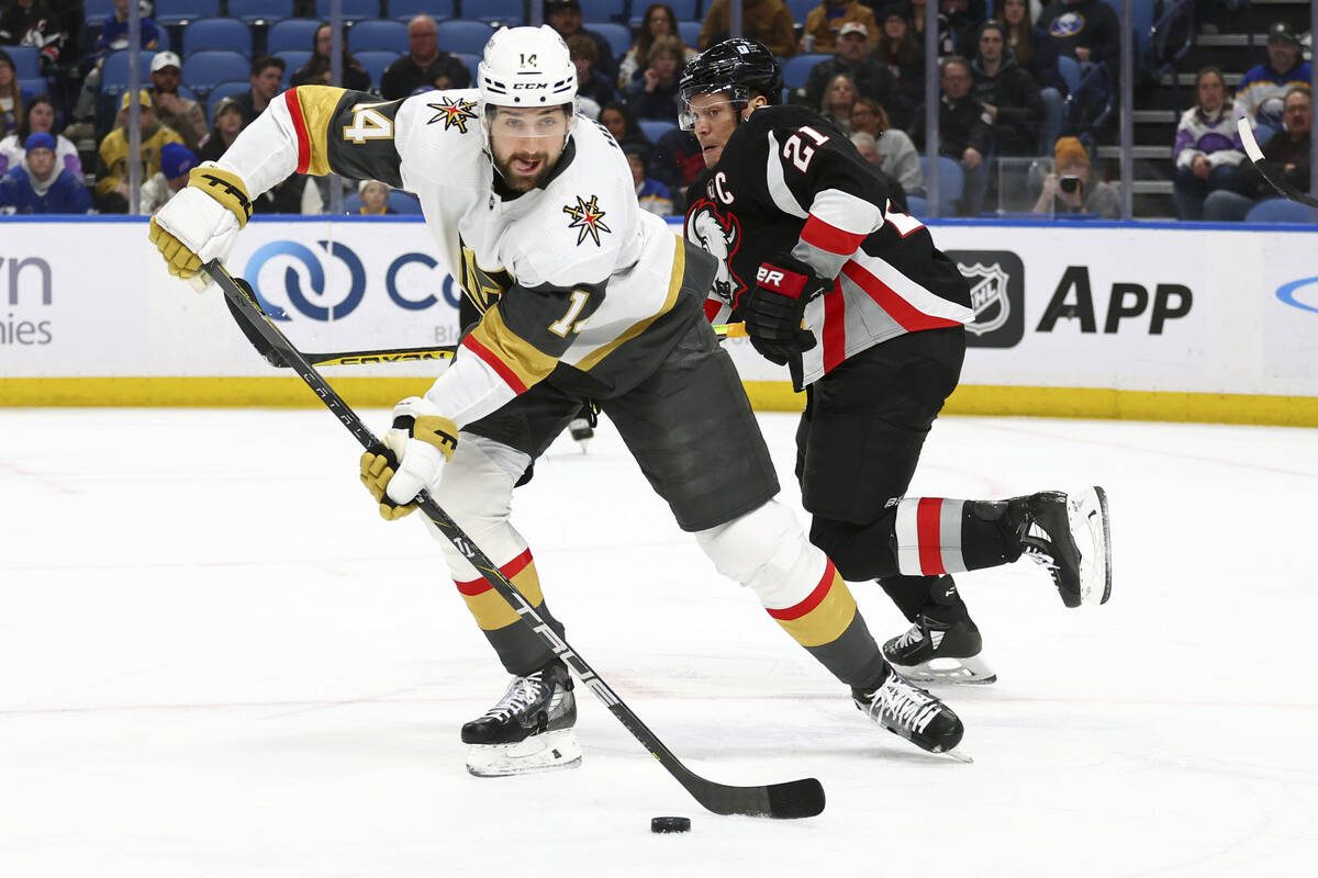 Vegas Golden Knights defenseman Nicolas Hague (14) carries the puck past Buffalo Sabres right w ...