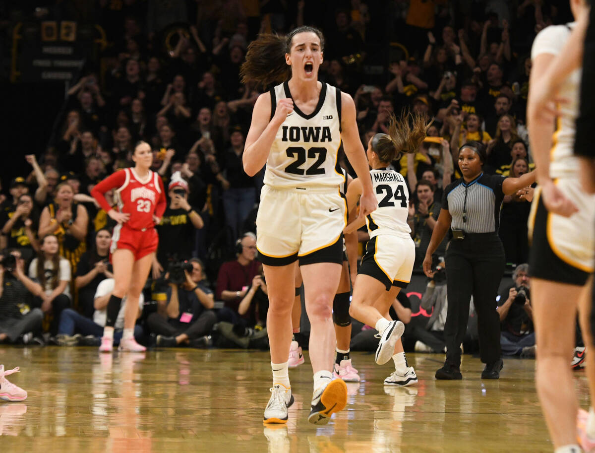 Iowa guard Caitlin Clark (22) celebrates after becoming the all-time leading scorer in NCAA Div ...