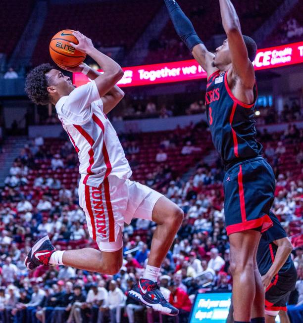 UNLV guard Dedan Thomas Jr. (11) sets up to shoot over San Diego State Aztecs guard Micah Parri ...