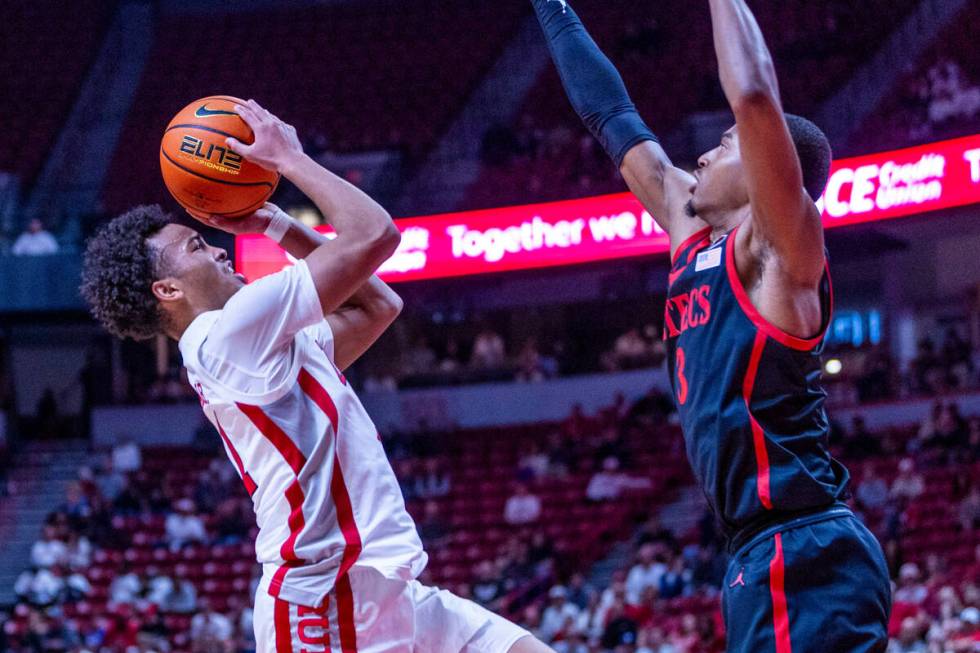 UNLV guard Dedan Thomas Jr. (11) sets up to shoot over San Diego State Aztecs guard Micah Parri ...