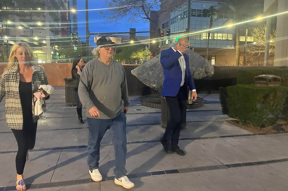 Daniel Rodimer, right, walks into the front entrance of the Clark County Detention Center with ...