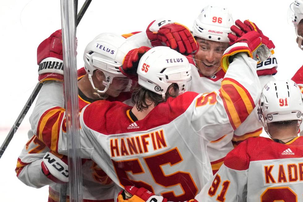 Calgary Flames defenseman Noah Hanifin (55) is congratulated by teammates after his goal agains ...