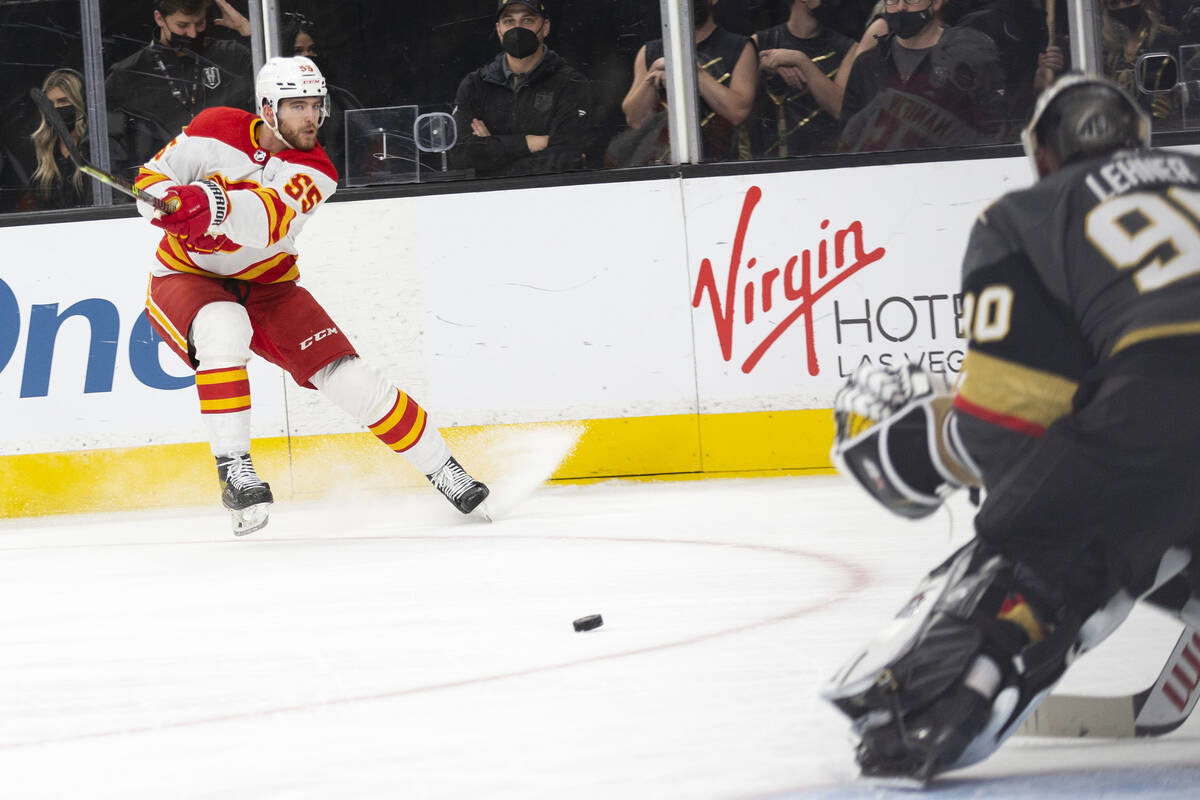 Calgary Flames defenseman Noah Hanifin (55) shoots against Vegas Golden Knights goaltender Robi ...