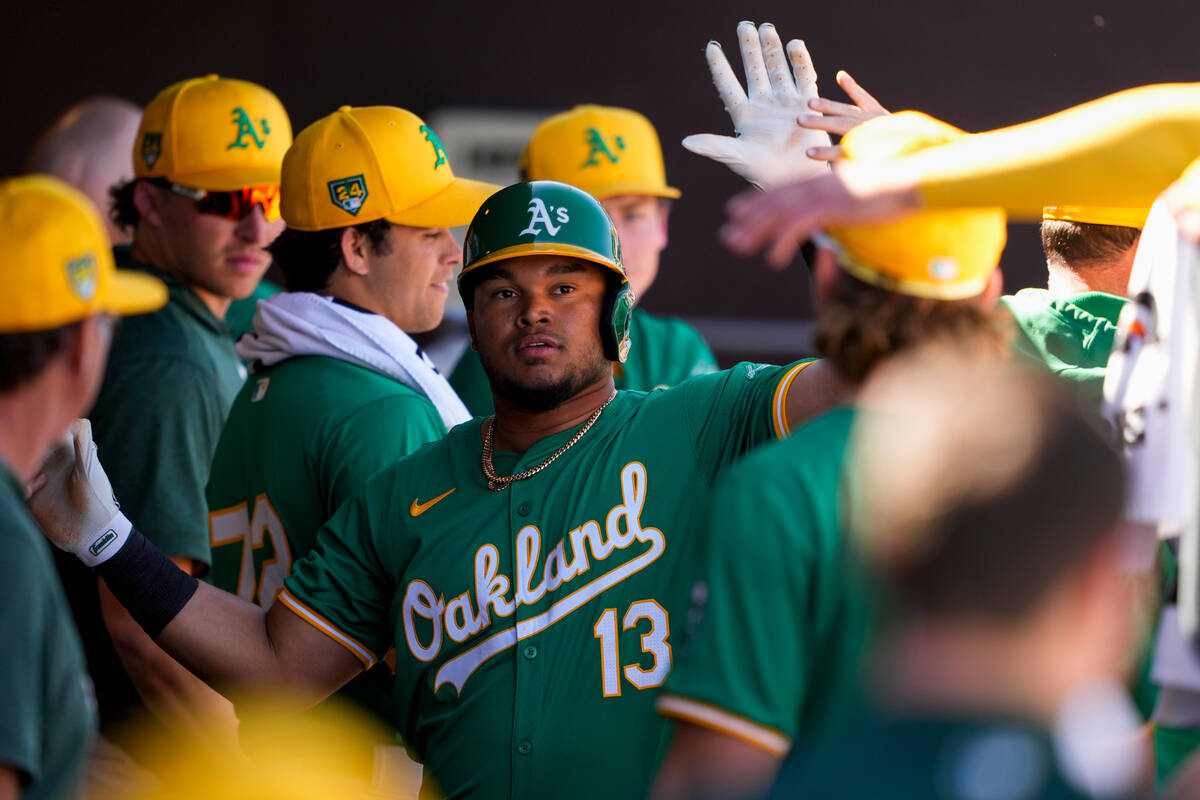 Oakland Athletics' Jordan Diaz is greeted in the dugout after scoring against the Seattle Marin ...