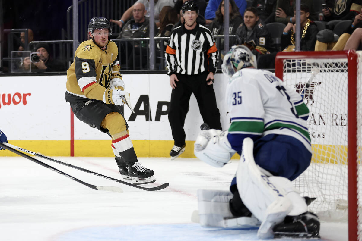 Golden Knights center Jack Eichel (9) attempts a goal on Canucks goaltender Thatcher Demko (35) ...