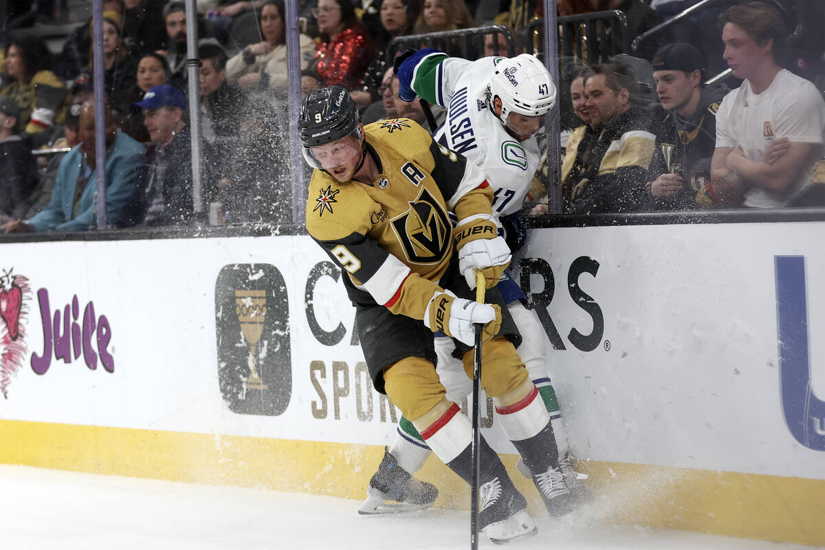 Golden Knights center Jack Eichel (9) checks Canucks defenseman Noah Juulsen (47) during the th ...