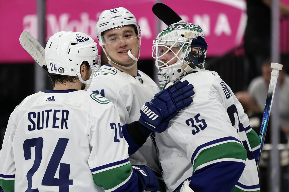 Canucks center Pius Suter (24), defenseman Nikita Zadorov (91) and goaltender Thatcher Demko (3 ...