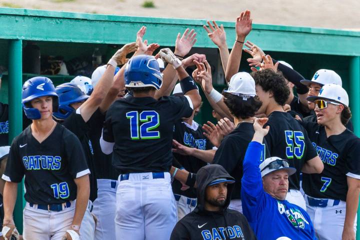 Green Valley batter Caden Kirby (12) is congratulated on a run by teammates against Silverado d ...
