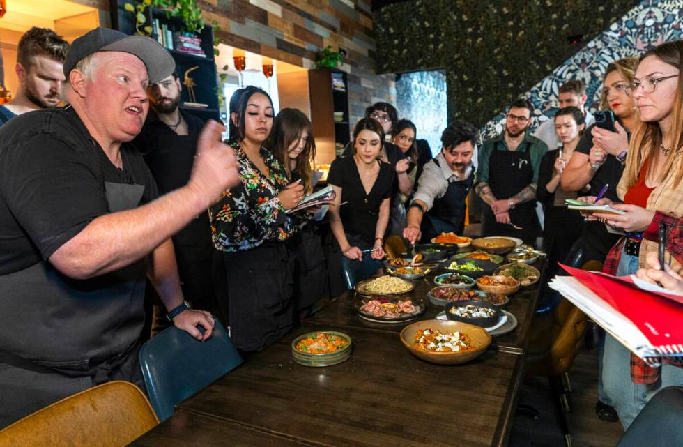 Esther's Kitchen chef/owner James Trees talks with his staff about each of their dishes and the ...