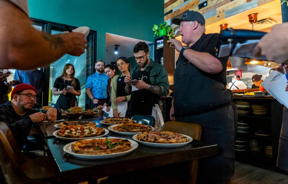 Esther's Kitchen chef/owner James Trees talks with his staff about each of their wood-fire oven ...