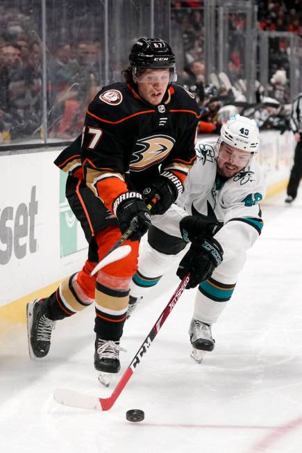 Anaheim Ducks left wing Rickard Rakell, left, and San Jose Sharks center Tomas Hertl battle for ...