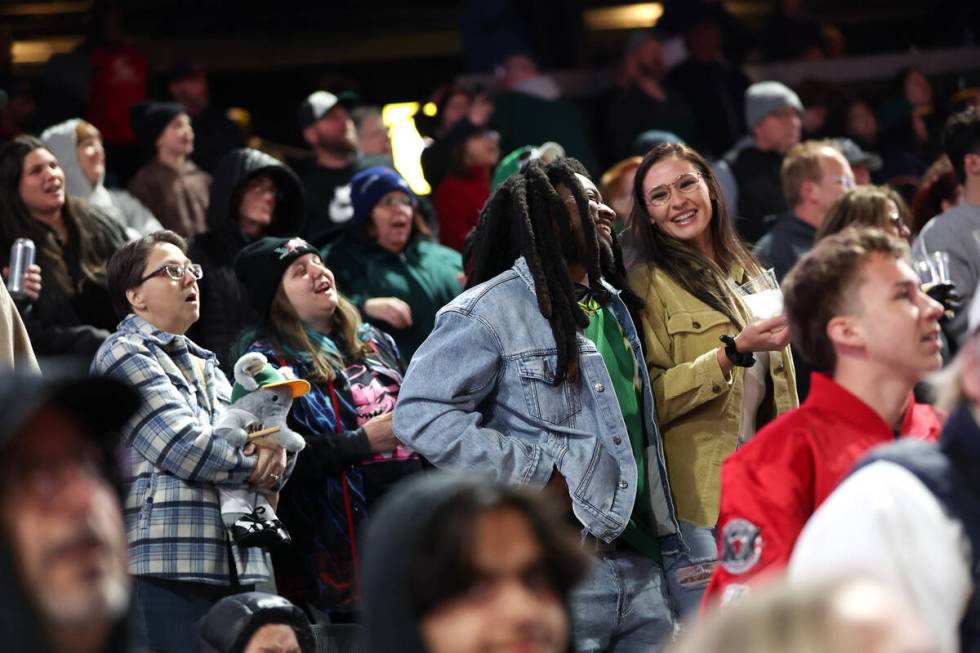 Fans sing during the seventh inning stretch during a Major League Baseball spring training game ...