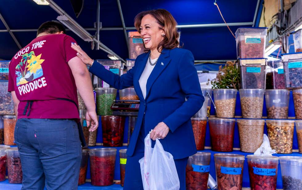 Vice President Kamala Harris thanks a vendor after making a purchase while on a stop to chat w ...