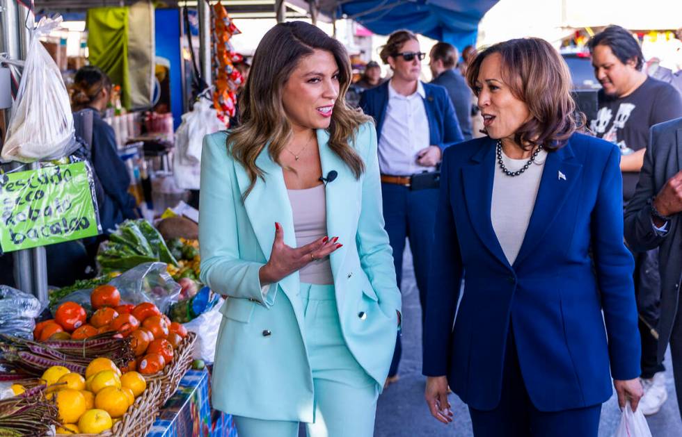 Vice President Kamala Harris talks with a reporter as she makes a stop to chat with people at B ...