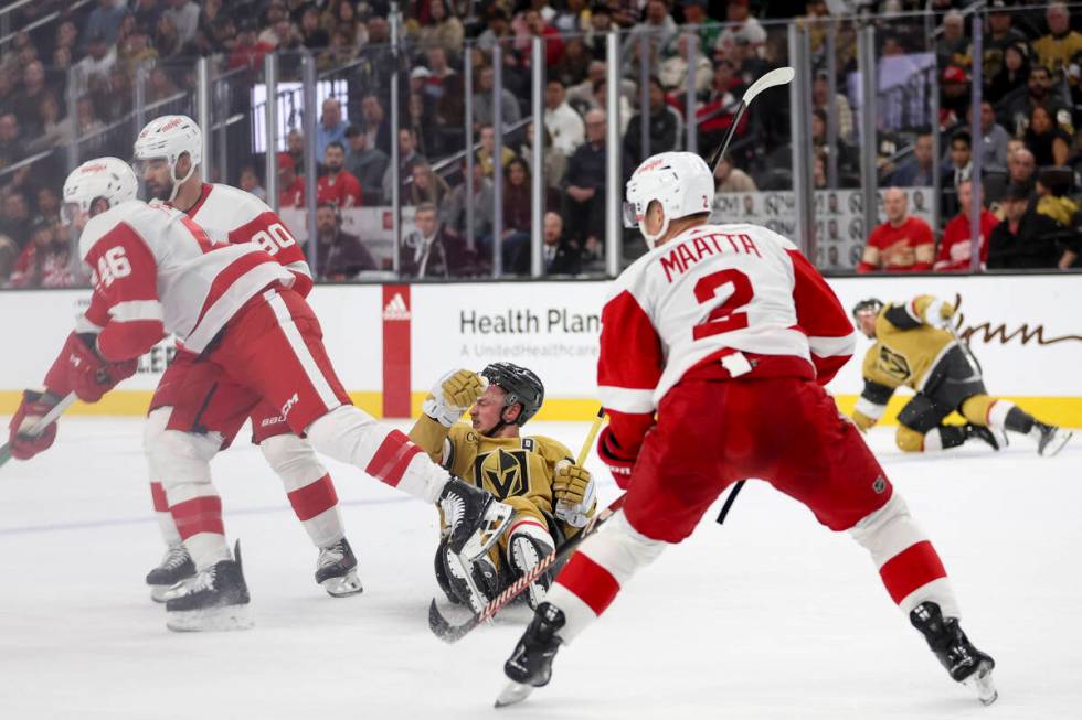 Golden Knights center Jack Eichel (9) falls to the ice after losing the puck to the Red Wings d ...