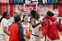 The UNLV Lady Rebels celebrate after defeating the Boise State Broncos in an NCAA college baske ...