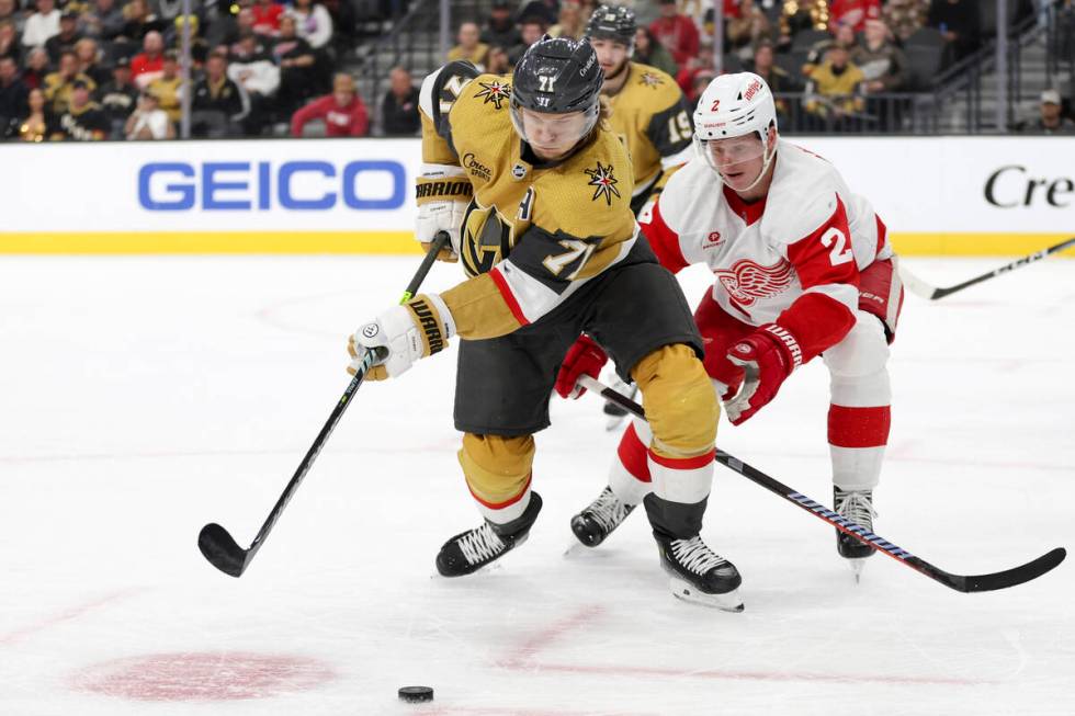 Golden Knights center William Karlsson (71) and Red Wings defenseman Olli Maatta (2) skate for ...