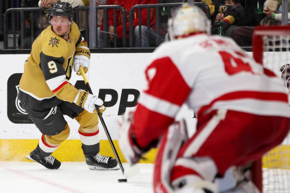 Golden Knights center Jack Eichel (9) looks to pass while Red Wings goaltender James Reimer (47 ...