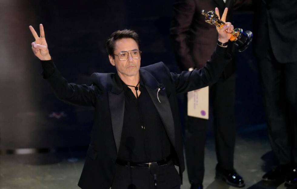Robert Downey Jr. accepts the award for best performance by an actor in a supporting role for " ...