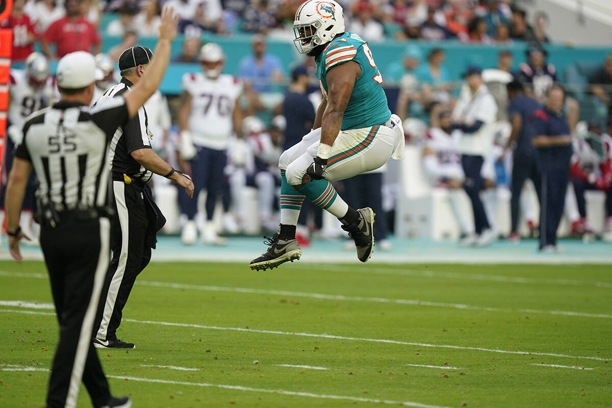 Miami Dolphins defensive end Christian Wilkins (94) leaps to celebrate a tackle during the firs ...