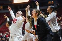 UNLV Lady Rebels players cheer their teammates from the sidelines in a game against Fresno Stat ...