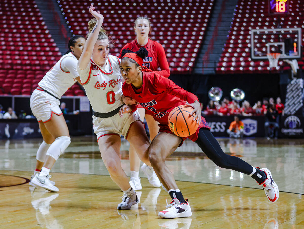 Fresno State’s guard Keely Brown (2) tries to push past UNLV’s guard Ashley Scogg ...
