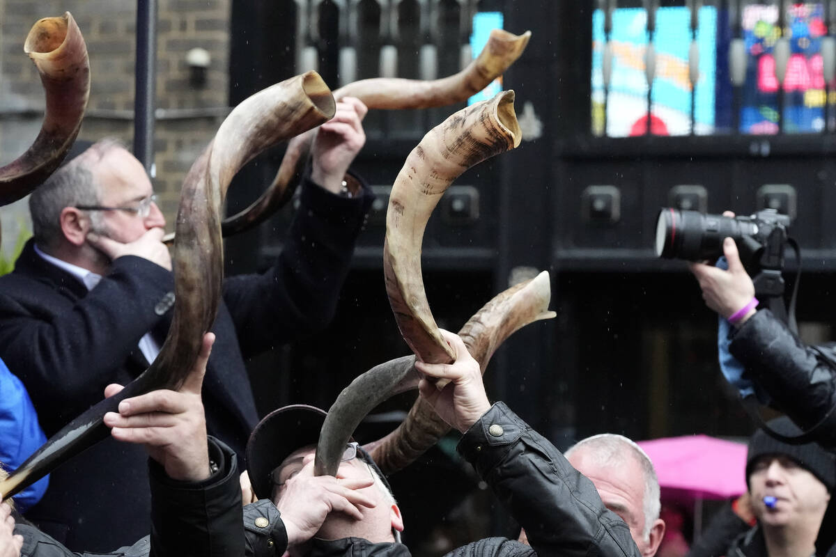 Jewish people and sympathisers blow shofars (ram's horns of spiritual significance) and whistle ...