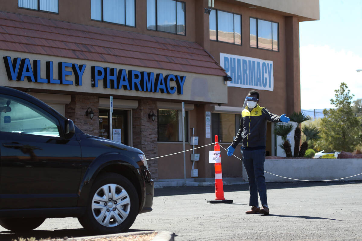 A lab technician directs people at the Sahara Urgent Care & Wellness center in Las Vegas, T ...