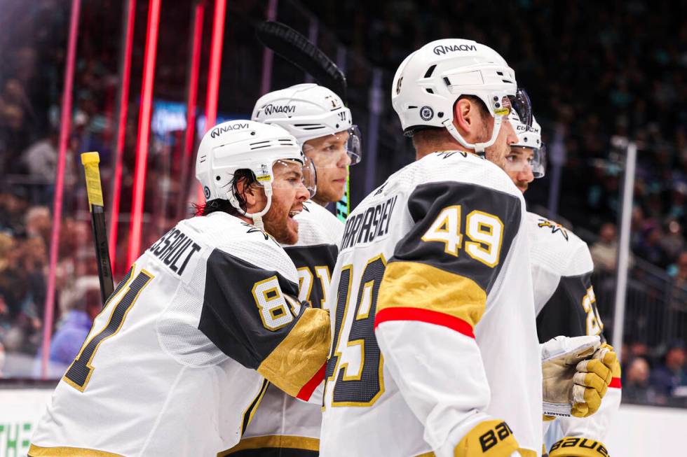 Vegas Golden Knights defenseman Shea Theodore is congratulated by teammates after a goal by rig ...