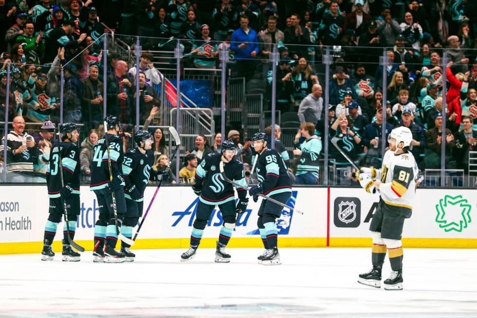 Vegas Golden Knights center Jack Eichel high fives teammates after a goal by right wing Jonatha ...