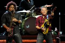 Bruce Springsteen, right, plays his guitar as Jake Clemons plays saxophone on stage during a co ...