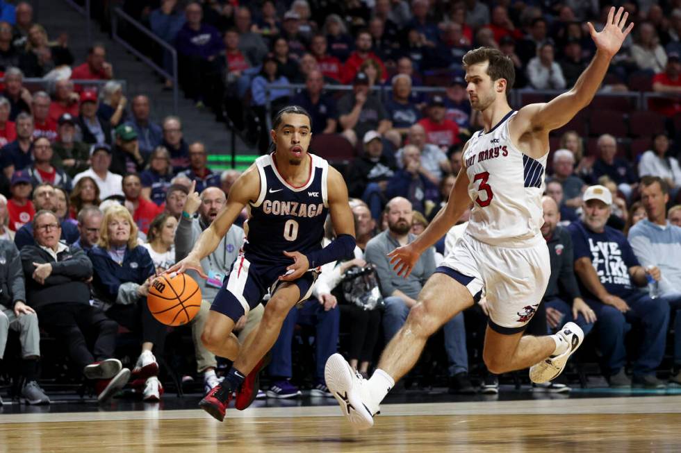 Gonzaga Bulldogs guard Ryan Nembhard (0) drives toward the hoop against St. Mary's Gaels guard ...