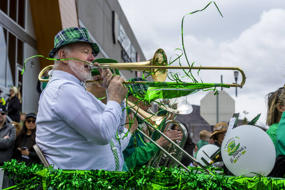 Streamers from a trombonist flutter in the wind as a band plays its way along the parade route ...