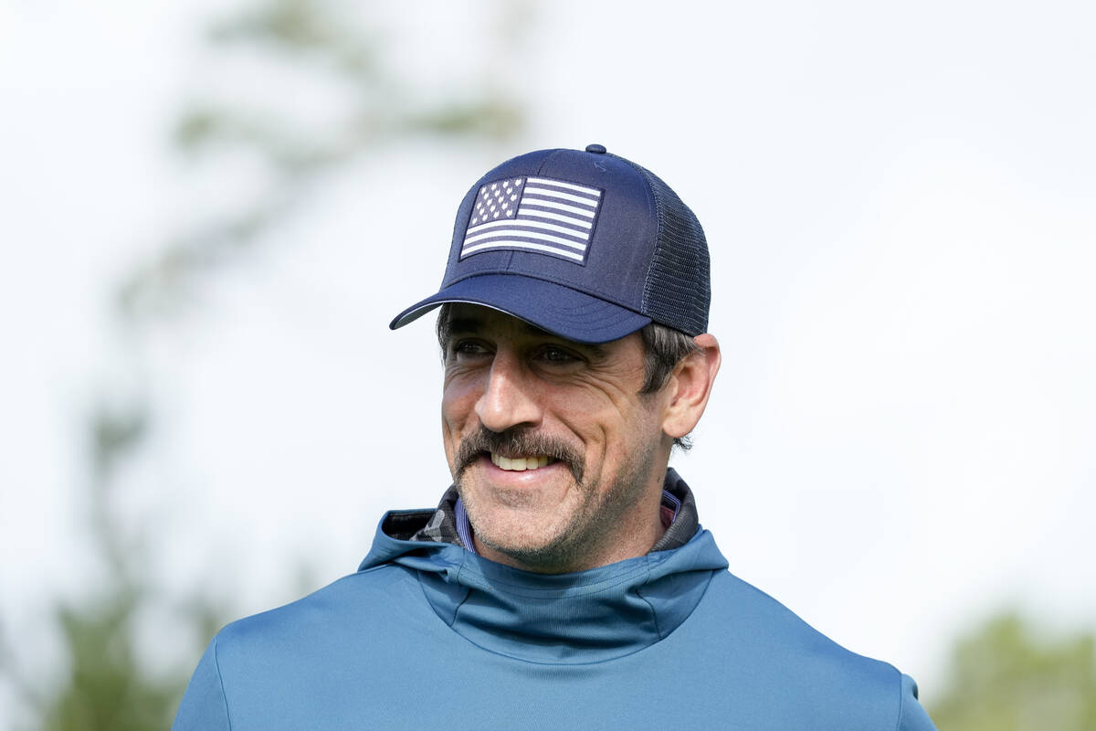 Aaron Rodgers walks off the 10th green on the Spyglass Hill Golf Course during the first round ...